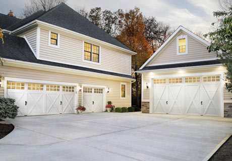modern house with white coachman garage doors