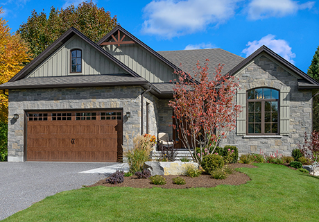 modern stone house with wooden garage door
