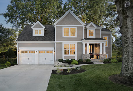 modern gray house with white garage doors