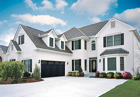 white modern house with black garage door